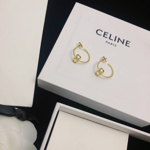 Celine's new gold Arc de Triomphe round stud earrings feature a unique and disti Celine's new gold Arc de Triomphe round stud earrings feature a unique and disti