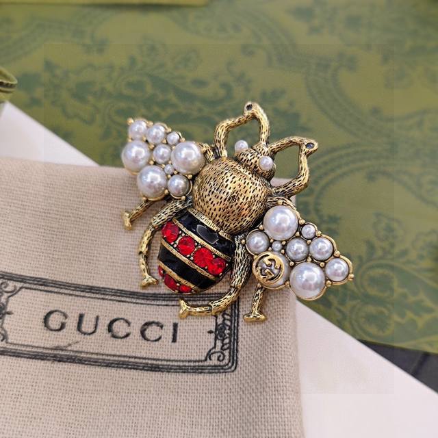 Gucci's Latest Chest Pin, Now Available At The Boutique. The Ultimate Accessory