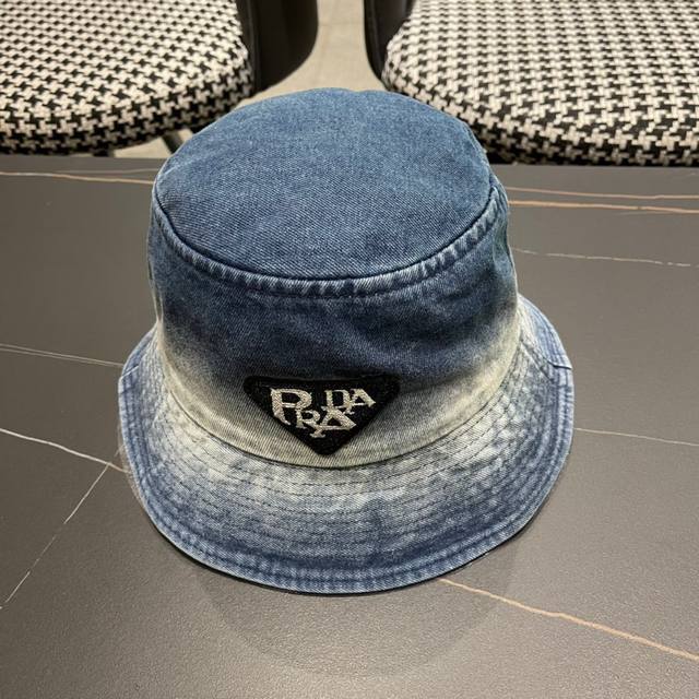 Prada's New Denim Bucket Hat Is Now On Sale. It's Easy To Match. Get It Now.