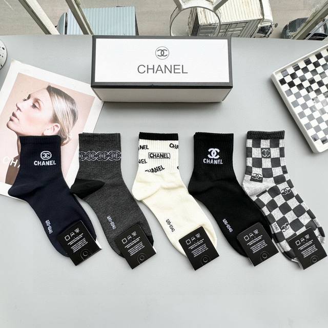 comes with a box of five pairs of Chanel's popular card-style middle-tube socks,