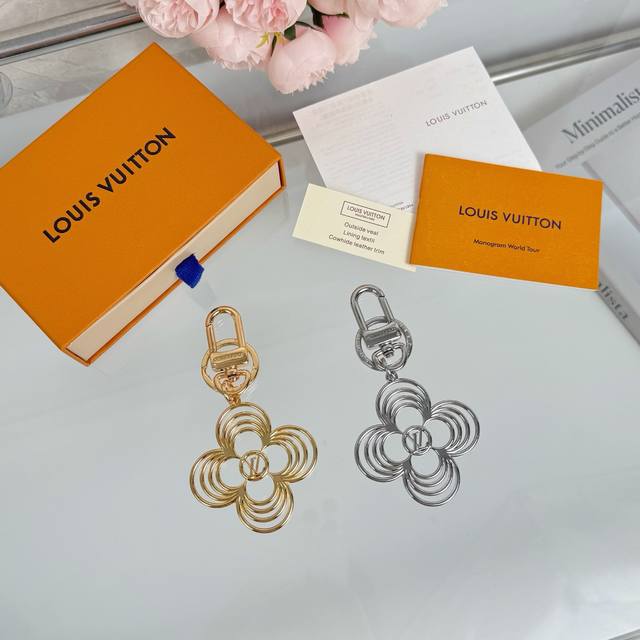 The Lv Breeze keychain interprets the floral configuration in a gentle style, wh