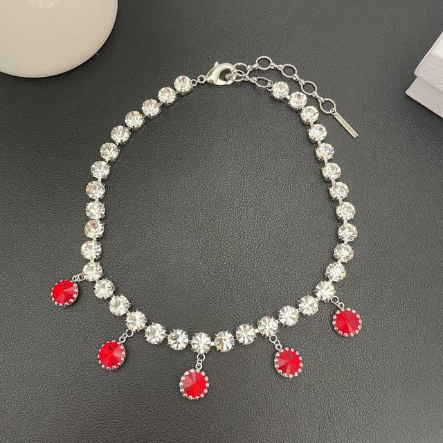 Alessandra Rich crystal tassel necklace has always been a benchmark in the simpl