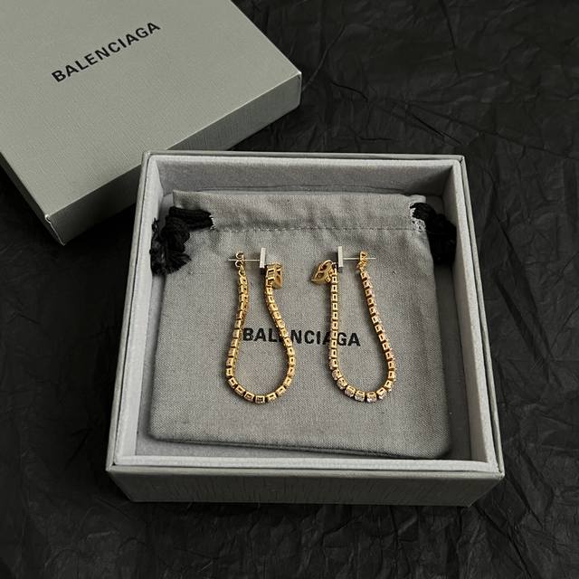 Balenciaga earrings are simple and elegant. They are rich in gold texture and lo