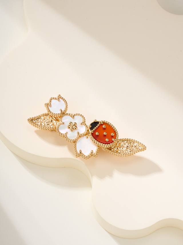 The Lucky Spring series features ladybug and flower themed brooches, with platin