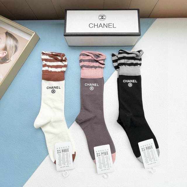 comes with a box of three pairs of Chanel's popular mid-tube socks, high versio