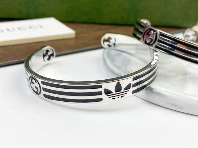 New arrival Gucci is decorated with Trefoil and three stripes. Adidas and Gucci