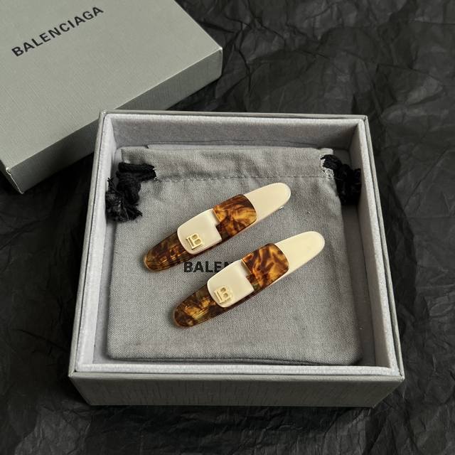 a pair, Balenciaga hairpins are simple and generous, with a rich gold texture,