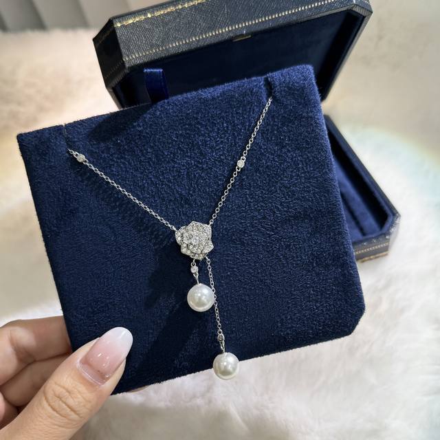 Piaget's new camellia pearl tassel necklace is the best foil for V-neck tube to