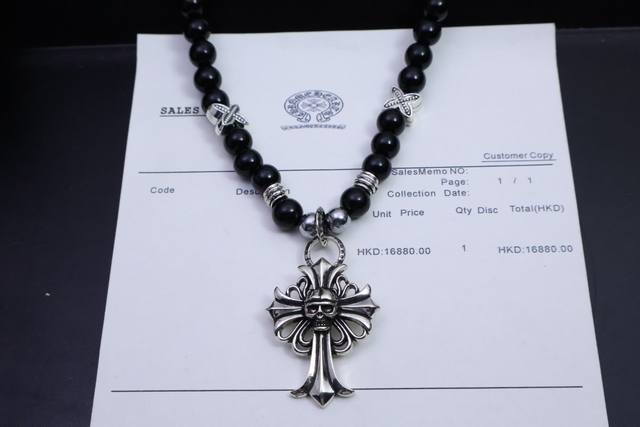 The Chrome Hearts necklace features cross and scout flower elements, full of Ch