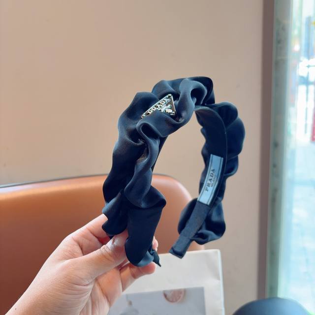 with packaging). Prada's new trendy pleated triangle logo headband. A must-have