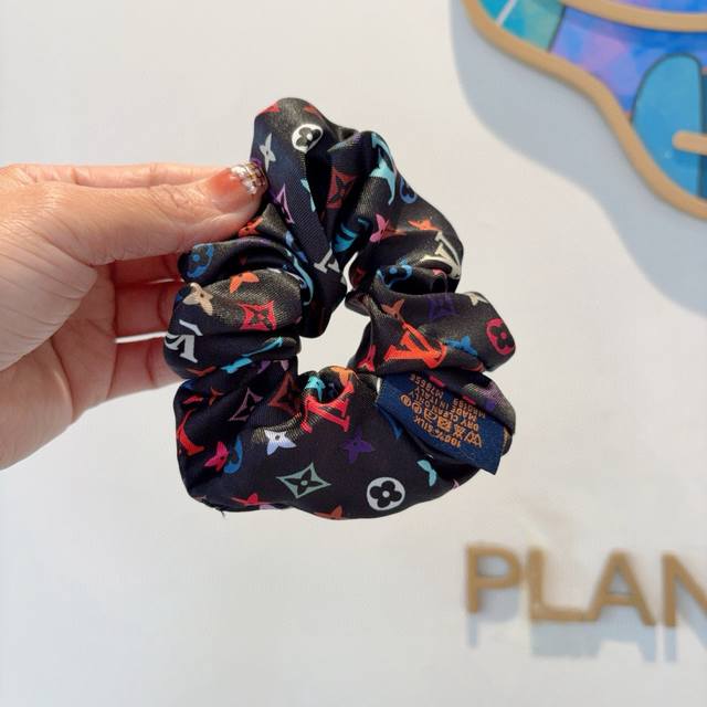 with Lv packaging. This Louis Vuitton silk scrunchie, featuring a delicate, inte