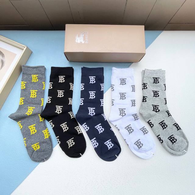 comes with a box of five pairs of Burberry's latest embroidered Tb socks, the la