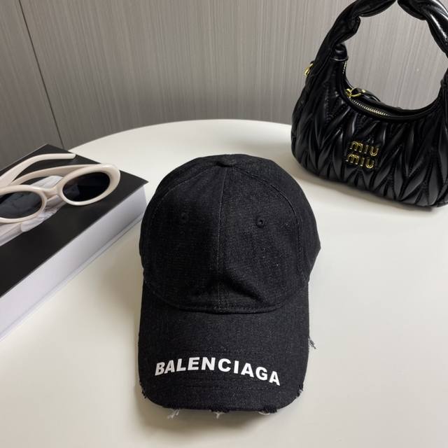 Balenciaga's new washed and distressed denim baseball cap. Newly launched washed