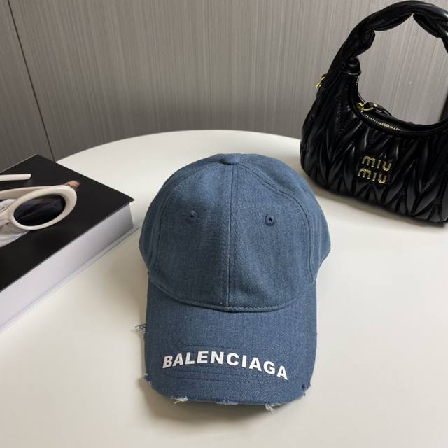Balenciaga's new washed and distressed denim baseball cap. Newly launched washed