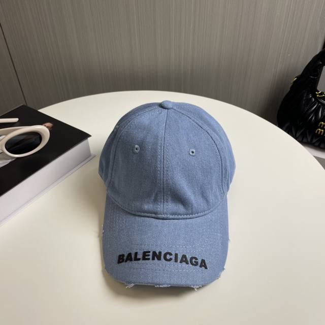 Balenciaga's new washed and distressed denim baseball cap. Newly launched washed