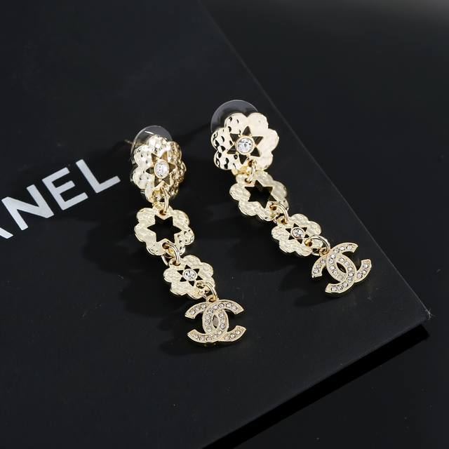 Chanel light gold earrings keep up with the trend of early spring earrings. Whet