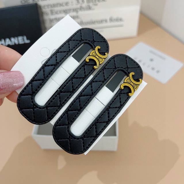 with packaging a pair of Celine Celine Arc de Triomphe new hair clips, classic B