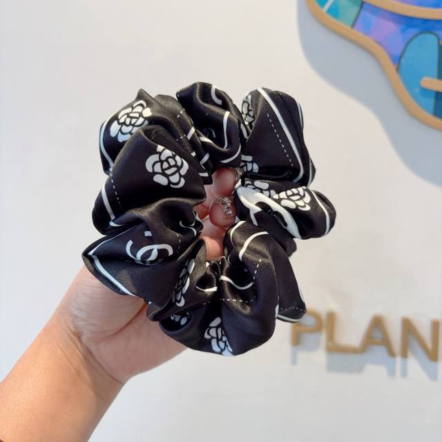 with packaging. This trendsetting Chanel hairband features a delicate, intestina
