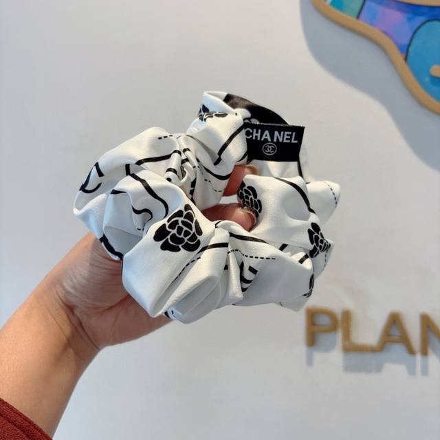 with packaging. This trendsetting Chanel hairband features a delicate, intestina