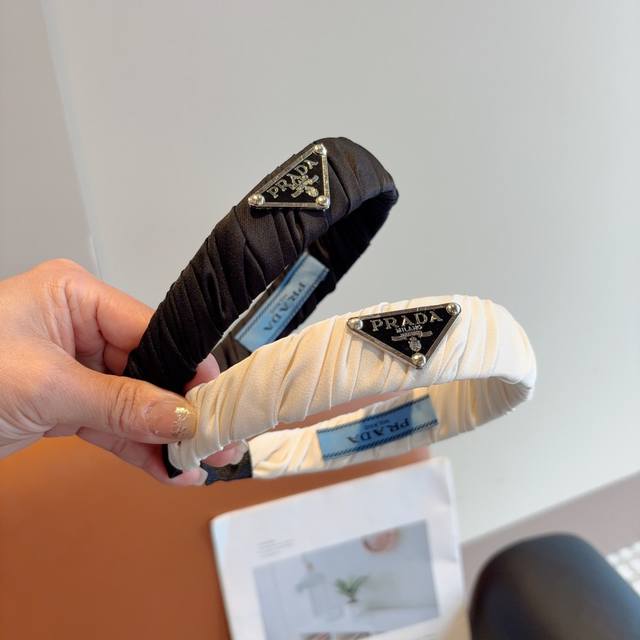 with packaging. Prada's new trendy lettered headband. A must-have for every eleg
