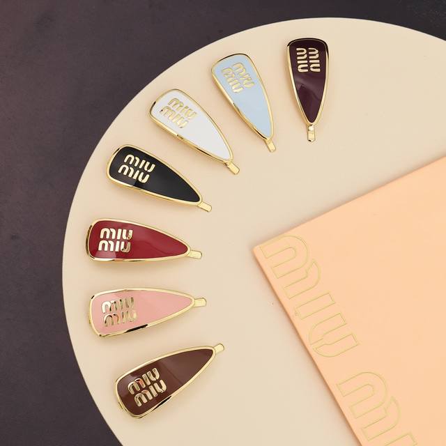 Miumiu candy-colored enamel letter hairpin. Miumiu's logo design elements are mi