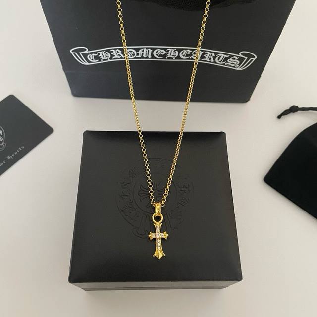 a counter-quality Chrome Hearts classic gold-tone pearl necklace with a cross pe