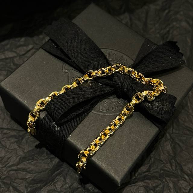 a counter-quality Chrome Hearts classic gold-tone letter bracelet. The concave a