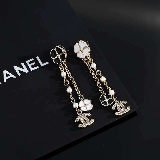 Chanel light gold black and white flower earrings keep up with the trend for ear