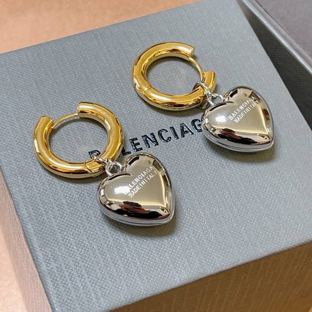 Balenciaga's earrings are updated at the counter with the simple hoop-shaped sta