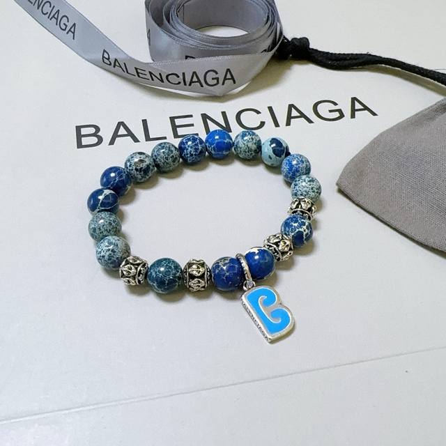 This Balenciaga bracelet features a natural snakeskin stone and lapis lazuli Tha
