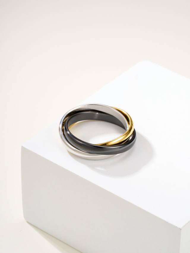 Black Ceramic Tinity Three-Ring Ring, US$6789. Made of yellow gold, white gold,