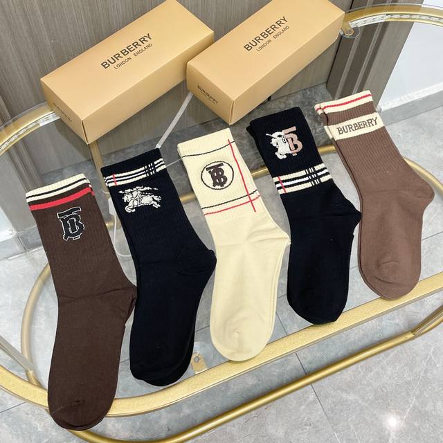 comes with a box of five pairs of Burberry's latest embroidered Tb socks, mid-l