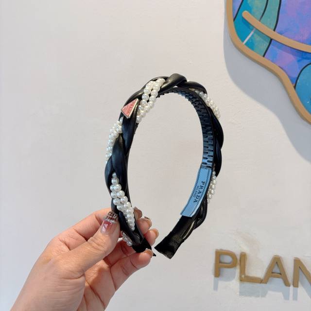 with packaging Prada's new trendy pearl headband. A must-have for a stylish god