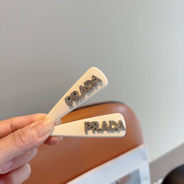 comes with a pair of Prada's new high-end hair clips, Bb clips, classic letter