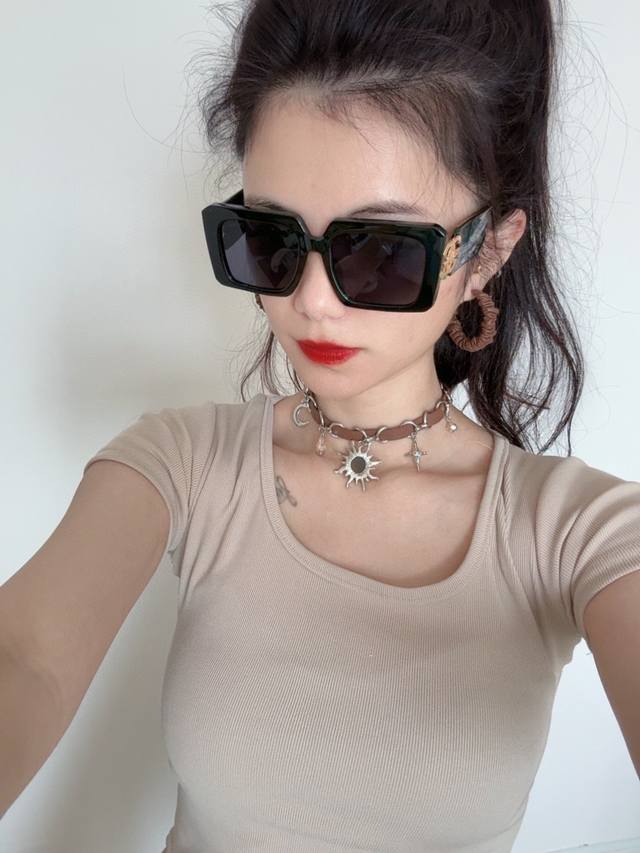 Chanel large-frame sunglasses. These sunglasses have a classic square design th