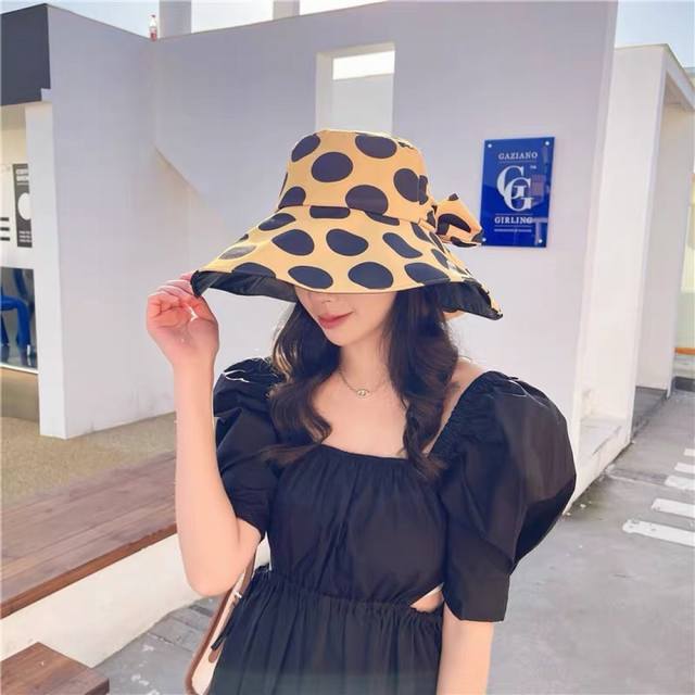 Prada's new polka dot triangle logo bucket hat, a big brand style that is super