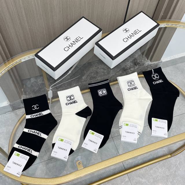 Comes with a box of five pairs of Chanel's popular mid-calf socks in the tall v