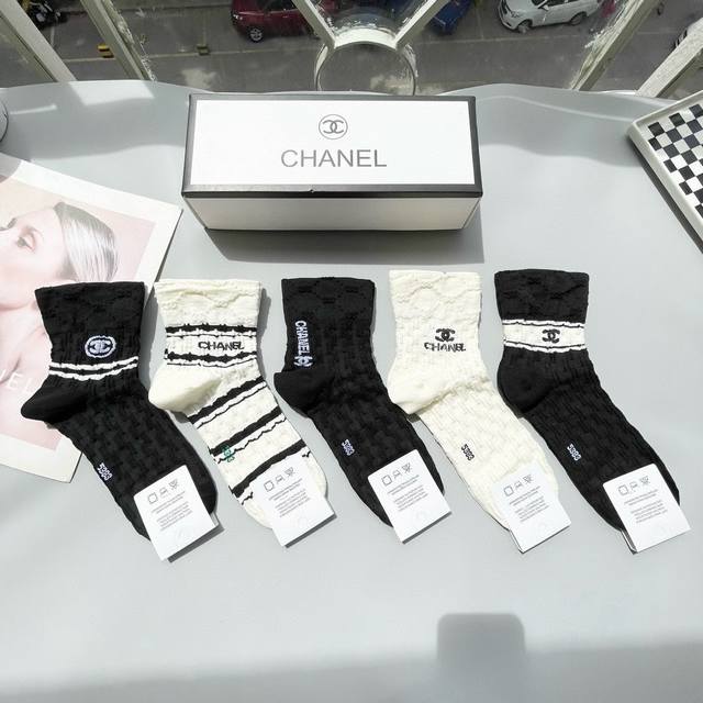 Comes with a box of five pairs of Chanel's popular mid-calf socks in the tall v