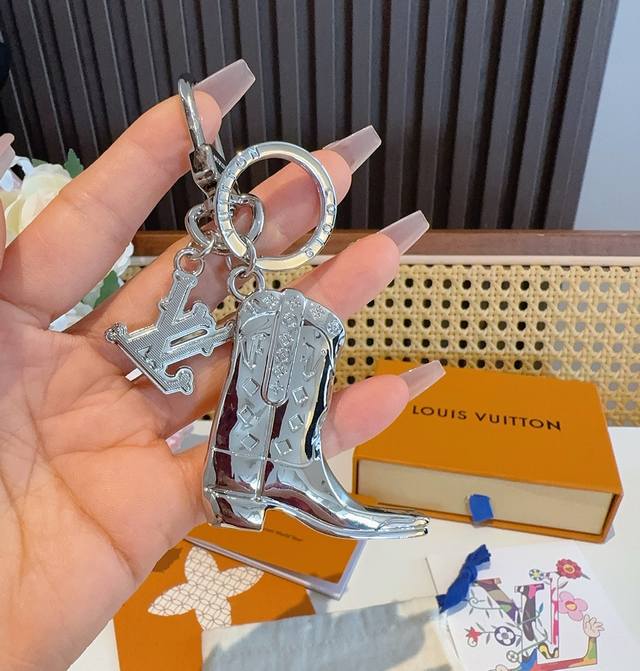 Lv keychain, boot charm, and car key charm feature the brand's signature logo cl