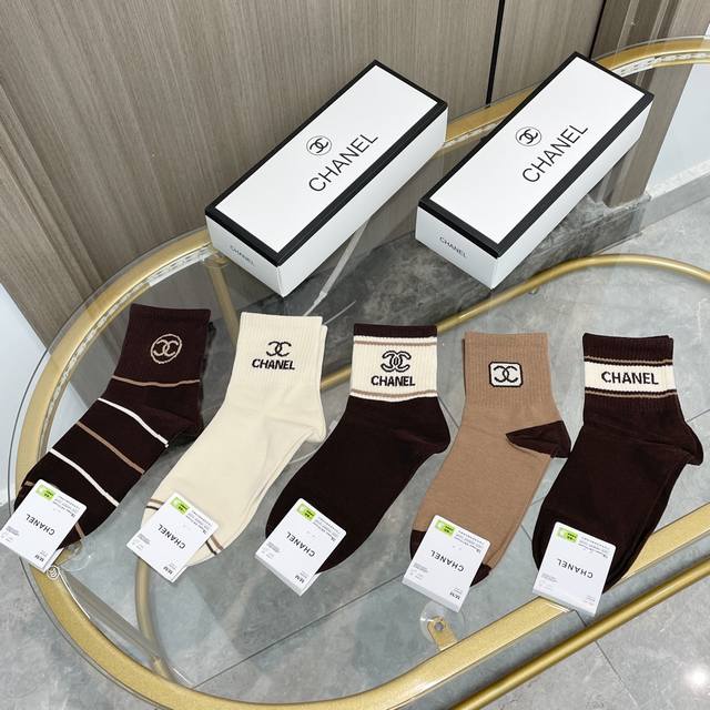Comes with a box of five pairs of Chanel's popular mid-calf socks in the tall v