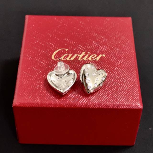 Cartier's high-end custom diamond-encrusted heart earrings feature diamond-encru