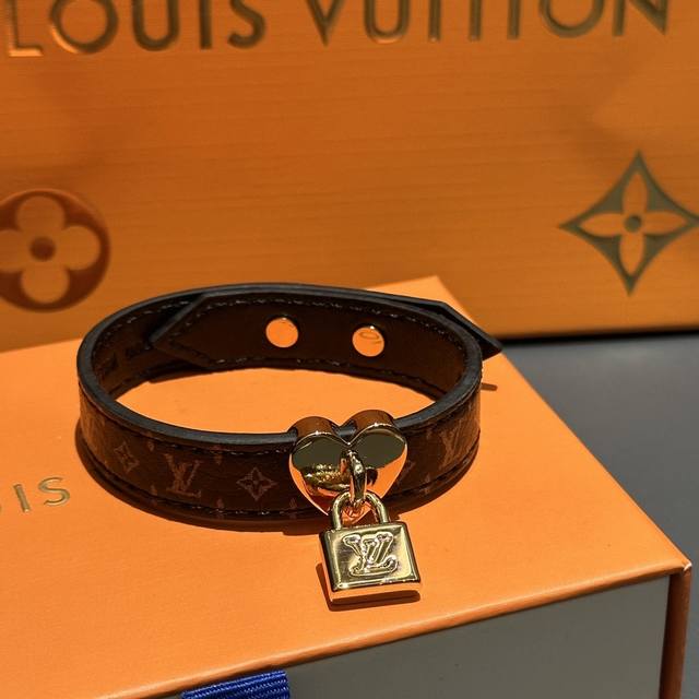 The Lock Me In Love bracelet features a wide Monogram leather loop adorned with