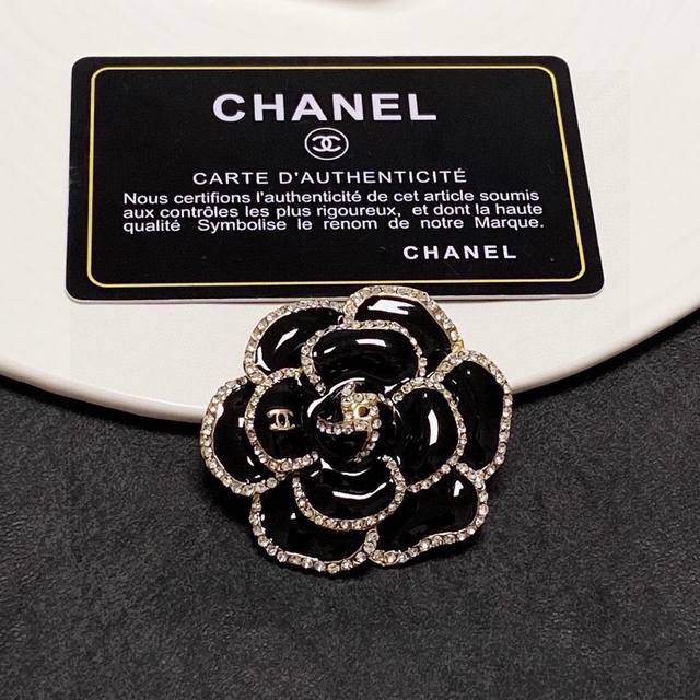 Chanel's new black camellia diamond brooch is a truly feminine accessory. Women