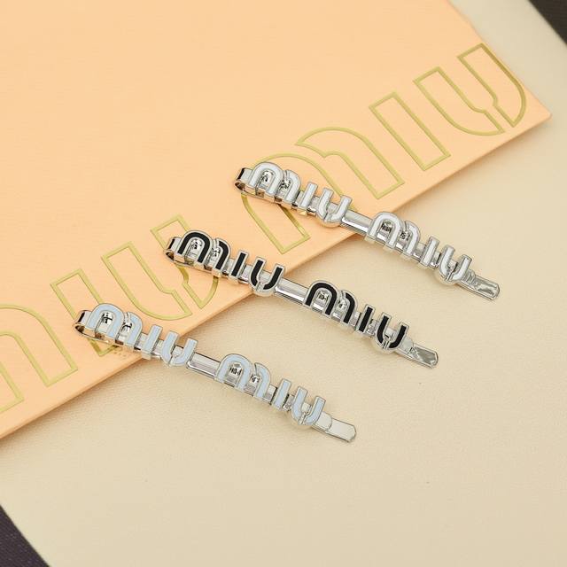 Miumiu candy-colored enamel hairpin Miumiu's logo design elements, minimalism, n