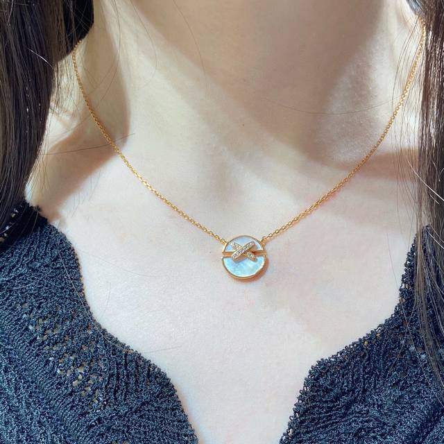 V gold. Chaumet cross-shaped round mother-of-pearl necklace. This heartwarming g