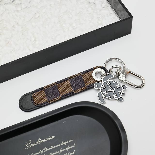 Dragonne Tab Bag Charm and Keychain M02564 The Dragonne Tab bag charm and keycha