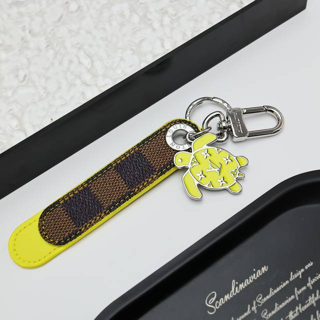 Dragonne Tab Bag Charm and Keychain M02564 The Dragonne Tab bag charm and keycha