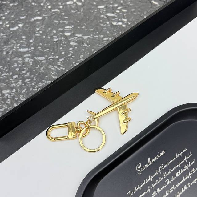 Lv Plane Bag Charm and Keychain M02542 The Lvplane bag charm and keychain reflec