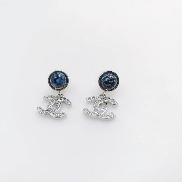 Chanel latest white gold and white diamond Cc earrings consistent with the Z bat