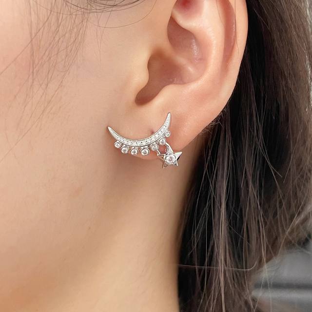 V Gold Material Single Chanel Star and Moon Earrings. A single piece of jewelry